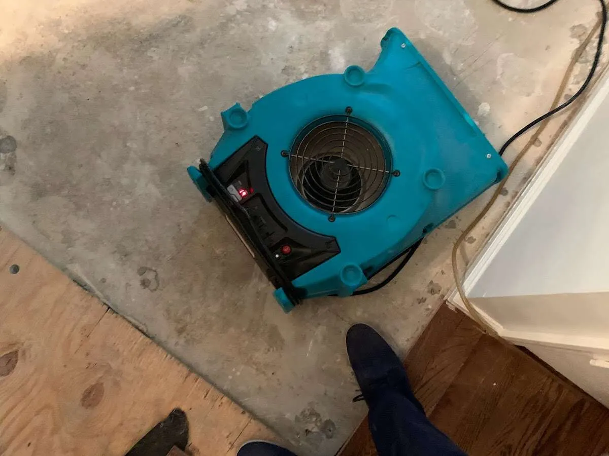 Air mover drying subfloor during Commercial Water Damage Restoration in Sugarmill Woods